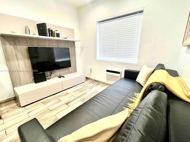 living room with wood-type flooring and a wall mounted AC