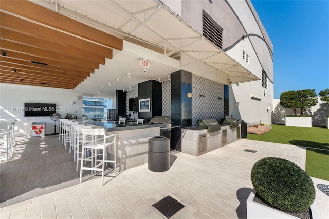 view of patio featuring a bar and area for grilling