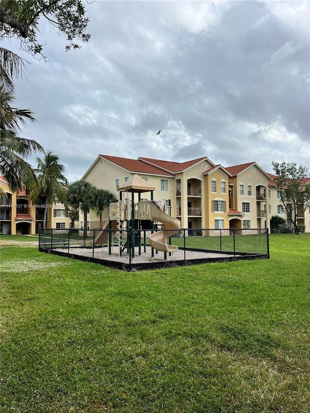 view of property's community featuring a playground and a yard