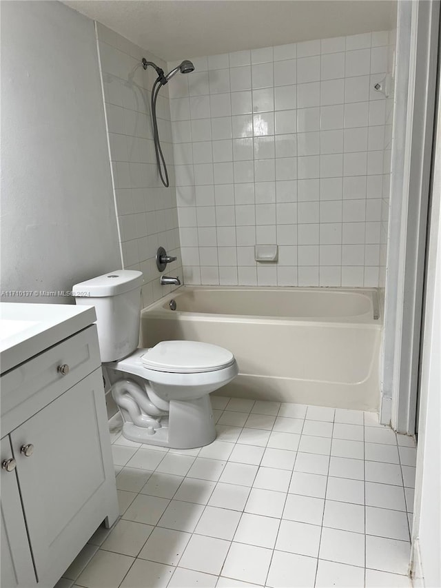 full bathroom with toilet, tile patterned floors, vanity, and tiled shower / bath combo