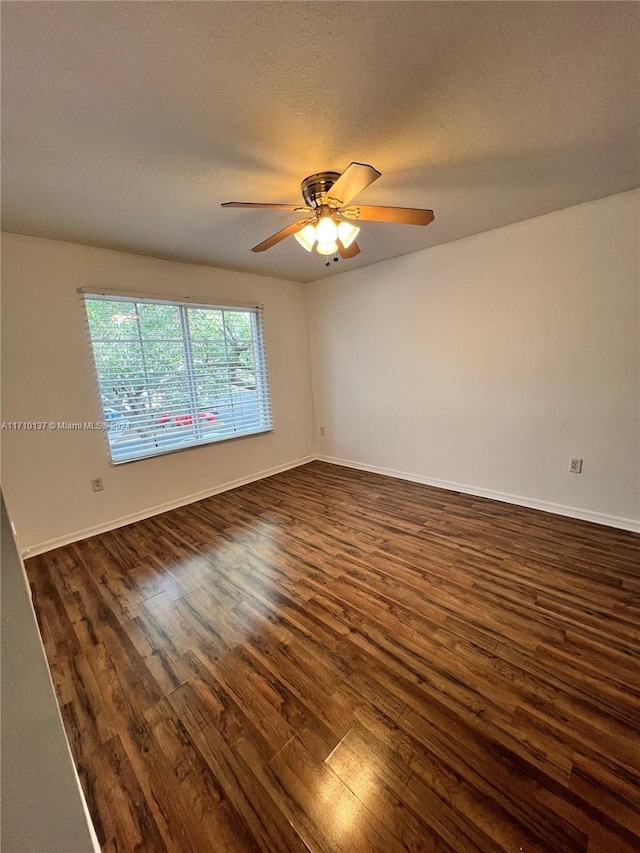 spare room with ceiling fan, dark hardwood / wood-style flooring, and a textured ceiling