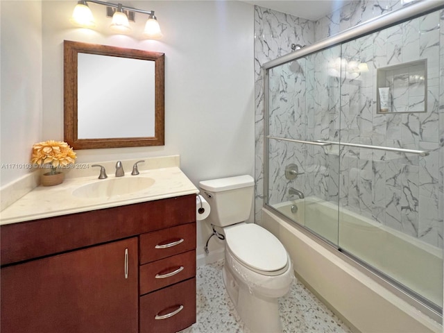 full bathroom featuring vanity, enclosed tub / shower combo, and toilet