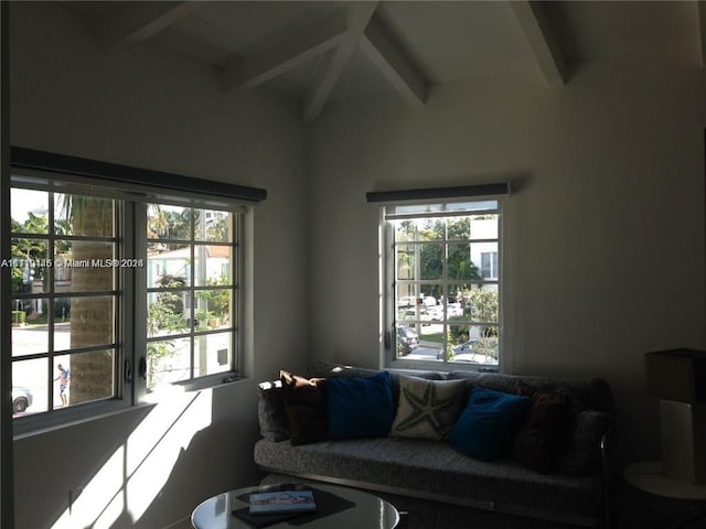 living room featuring lofted ceiling with beams