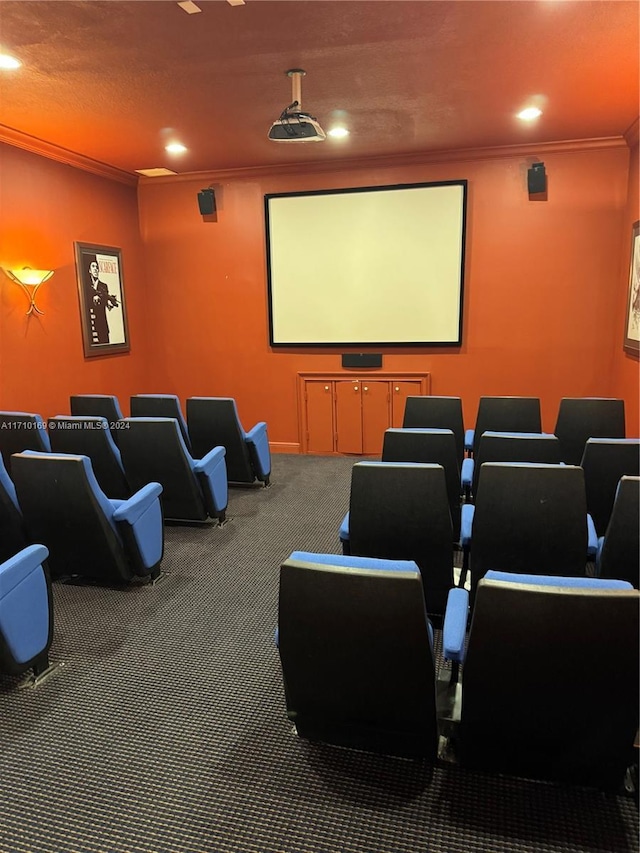 carpeted home theater room featuring ornamental molding