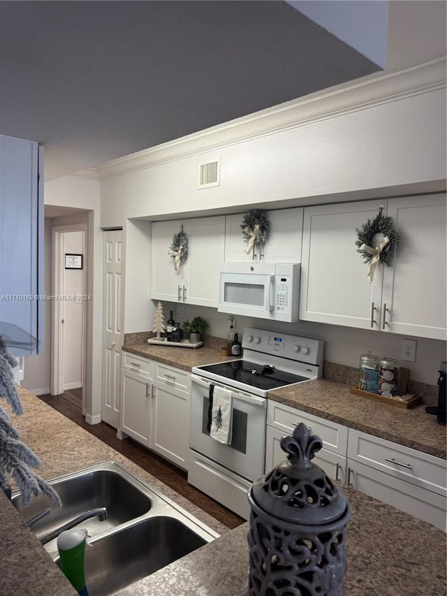 kitchen featuring sink, dark wood-type flooring, crown molding, white appliances, and white cabinets