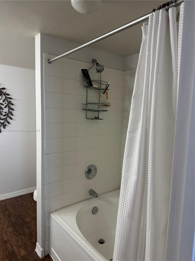 bathroom featuring toilet, shower / bath combination with curtain, and hardwood / wood-style flooring