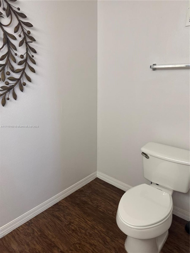 bathroom with hardwood / wood-style floors and toilet