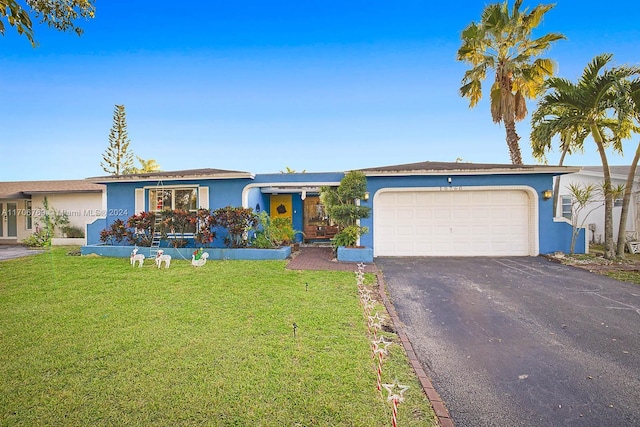 single story home featuring a front yard and a garage