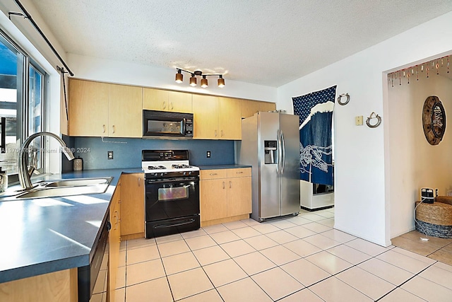 kitchen with light brown cabinets, sink, a textured ceiling, and black appliances