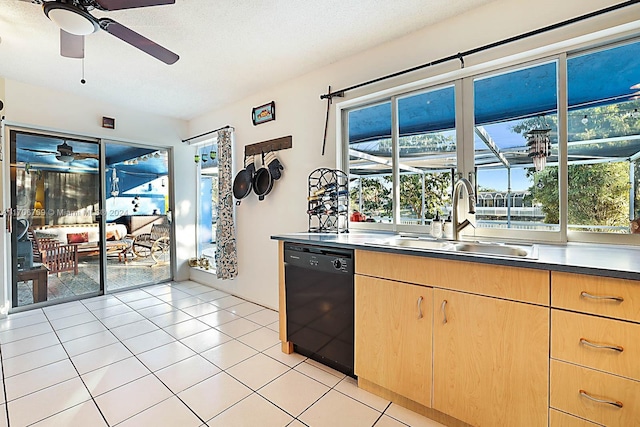 kitchen with light tile patterned flooring, black dishwasher, plenty of natural light, and sink