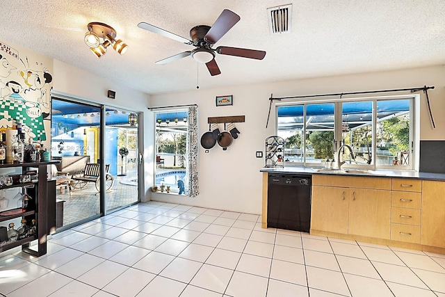 kitchen with light brown cabinetry, a textured ceiling, ceiling fan, sink, and dishwasher