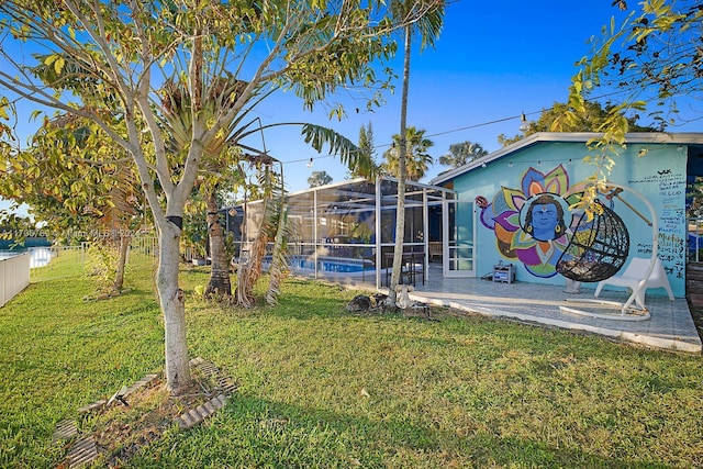 view of yard featuring a fenced in pool and glass enclosure