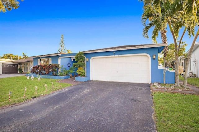 ranch-style home with a front lawn and a garage