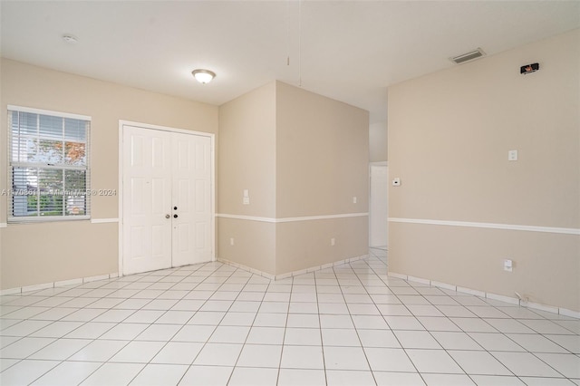 unfurnished room with light tile patterned floors