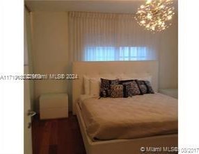 bedroom featuring an inviting chandelier