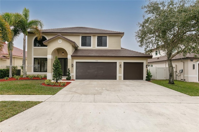 mediterranean / spanish-style house featuring a front yard and a garage