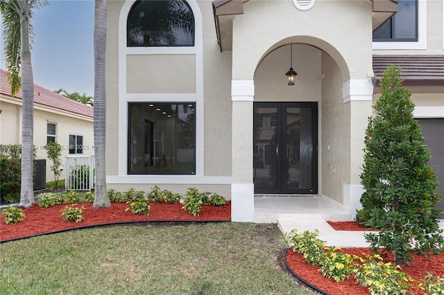 view of exterior entry with cooling unit and french doors