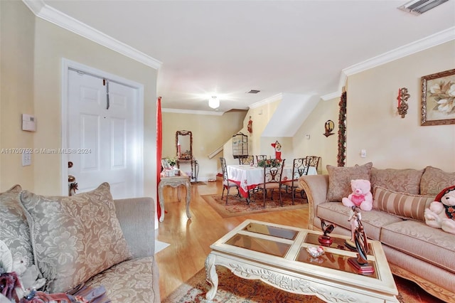 living room with light wood-type flooring and ornamental molding