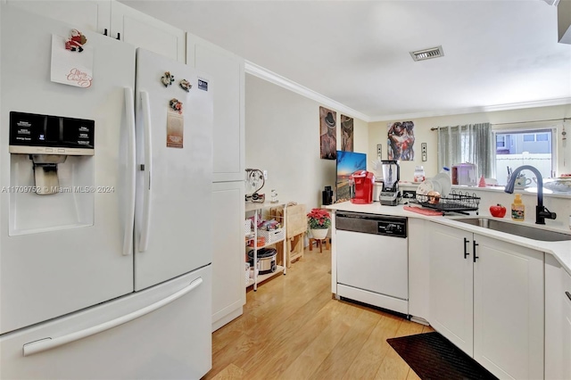 kitchen featuring white cabinetry, sink, light hardwood / wood-style flooring, white appliances, and ornamental molding