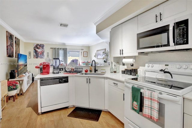 kitchen with white appliances, crown molding, sink, light hardwood / wood-style flooring, and white cabinetry