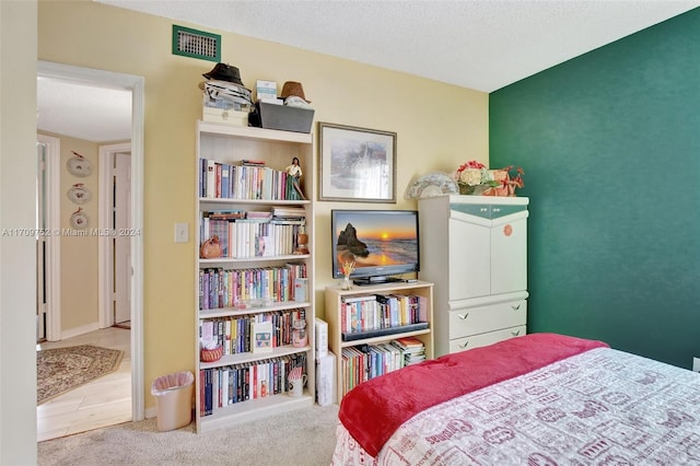 carpeted bedroom with a textured ceiling