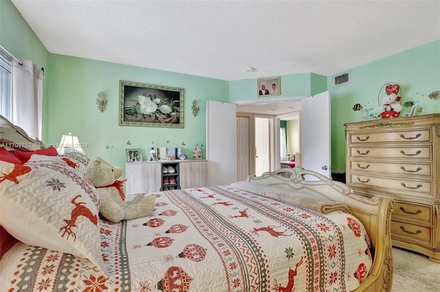 carpeted bedroom featuring a textured ceiling