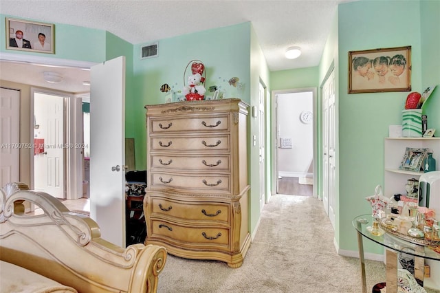 carpeted bedroom with a textured ceiling