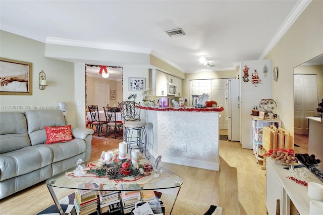 living room featuring light hardwood / wood-style flooring and ornamental molding