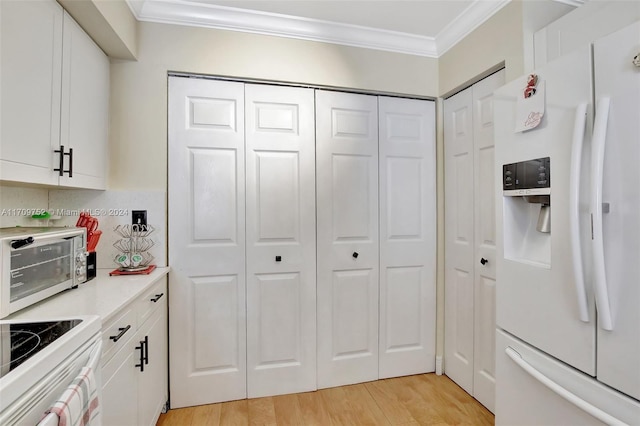 kitchen featuring white cabinetry, backsplash, crown molding, light hardwood / wood-style floors, and white appliances