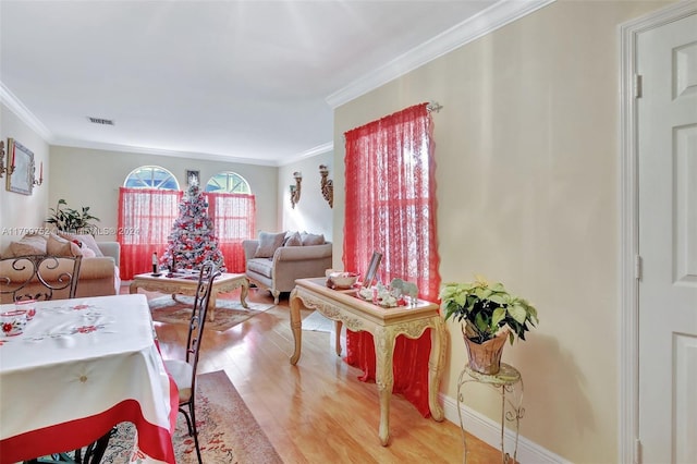 interior space featuring hardwood / wood-style flooring and crown molding