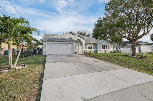 view of front of home featuring a garage and a front lawn