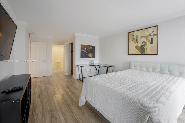 bedroom featuring hardwood / wood-style flooring and crown molding