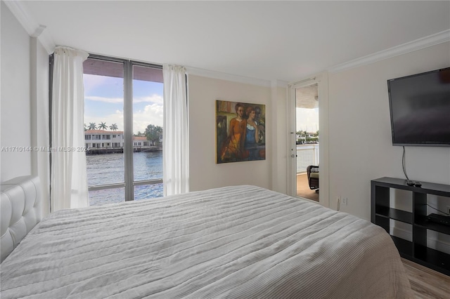 bedroom featuring access to exterior and crown molding