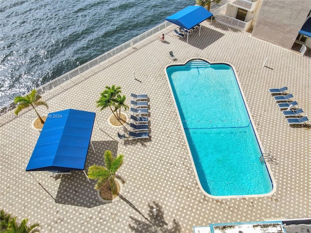 view of pool with a water view