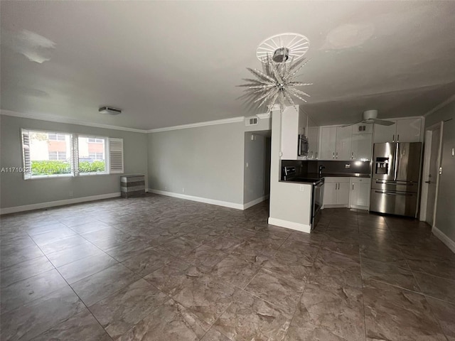 unfurnished living room featuring crown molding and a notable chandelier