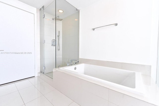 bathroom featuring tile patterned floors and shower with separate bathtub