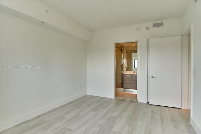 empty room with light hardwood / wood-style flooring