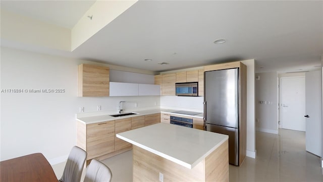 kitchen with light brown cabinetry, sink, white cabinets, a center island, and black appliances