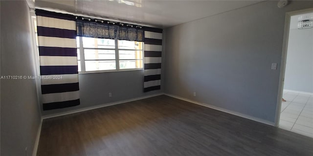 spare room featuring dark hardwood / wood-style floors