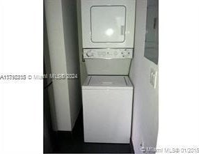 laundry room featuring stacked washing maching and dryer