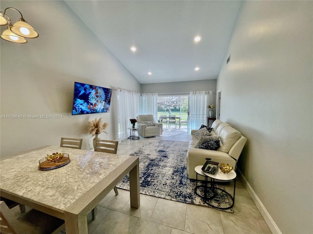 living room featuring high vaulted ceiling and light tile patterned floors