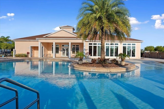 view of pool with a patio and french doors