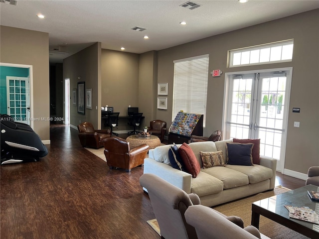 living room featuring a textured ceiling and dark hardwood / wood-style flooring