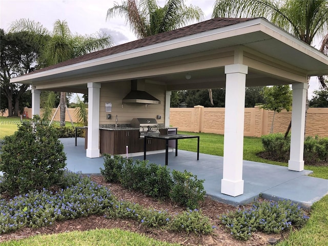 view of patio / terrace with a gazebo, an outdoor kitchen, sink, and grilling area