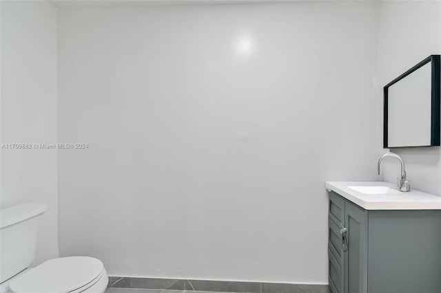 bathroom featuring toilet, vanity, and tile patterned floors