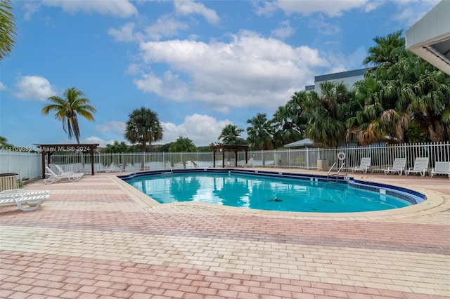 view of swimming pool featuring a pergola and a patio