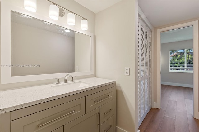 bathroom with vanity and wood-type flooring