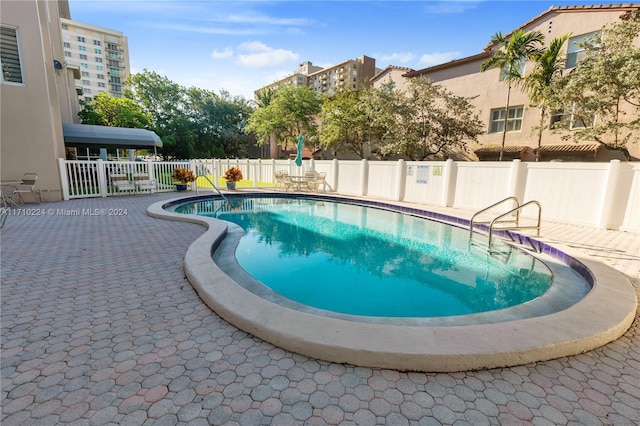 view of swimming pool with a patio area