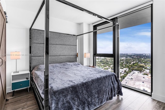 bedroom with hardwood / wood-style floors and floor to ceiling windows