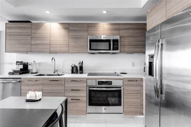 kitchen featuring sink, light tile patterned floors, and stainless steel appliances